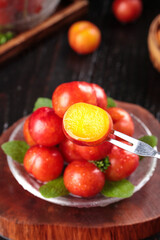 Fresh Red Plums with Golden Flesh Arrangement on Glass Plate with Mint Leaves and Fork