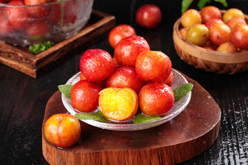 Fresh Red and Yellow Plums on Glass Plate with Water Droplets - Organic Stone Fruit Display