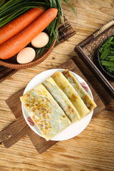 Homemade leek pancakes with fresh vegetables in rustic kitchen setting, healthy breakfast food preparation