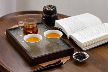 Traditional Chinese Puerh Tea Ceremony Setup with Handmade Teaware and Book