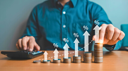 Businessman managing financial growth, stacking coins in a rising graph with percentage icons for investment return and interest rate concepts