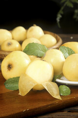 Fresh Loquat Fruits with Mint Leaves on Wooden Board - Healthy Organic Produce