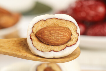Fresh Date Fruit Cut in Half Showing Sweet Flesh and Pit on Wooden Spoon