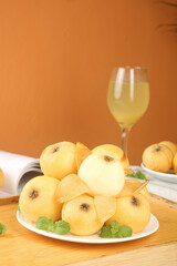 Fresh Dongshan Loquat Fruits from Suzhou on White Plate with Wine Glass