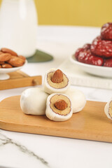 Handmade Almond-Filled White Confections with Dates and Nuts on Wooden Board