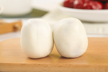 Fresh Handmade Mozzarella Cheese Balls on Wooden Cutting Board in Kitchen