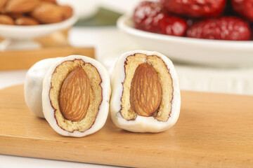 Handmade Date Almond Sweets with Creamy White Coating on Wooden Board - Traditional Middle Eastern Confection