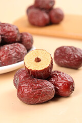 Xinjiang Ruoqiang Dried Jujube Dates with Cross Section on Wooden Background