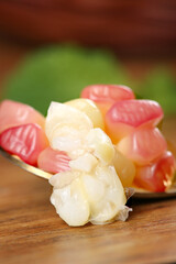 Sweet Gummy Candies with Flower Shaped Treats on Wooden Background