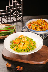 Sautéed Shrimp and Green Peas Asian Style Dish on White Plate with Traditional Table Setting