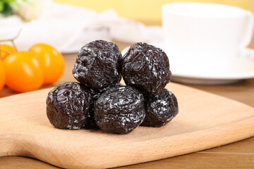 Dried Xinjiang Tianshan Plums - Sweet Sour Woody Flavored Chinese Dried Fruits on Wooden Board