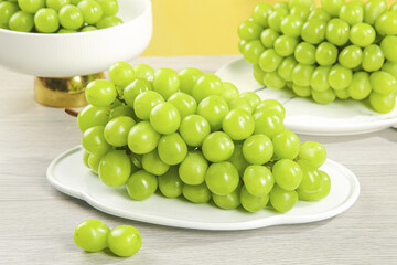 Fresh Green Grapes on White Plates - Healthy Fruit Display with Sunny Natural Lighting