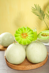 Fresh Green Melons in Wicker Basket with Palm Leaf Natural Lighting Food Photography