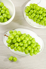 Fresh Green Grapes in White Bowls on Wooden Table - Healthy Organic Fruit