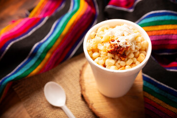 Esquites. Corn kernels cooked and served with mayo, sour cream, lemon and chili powder, very popular street food in Mexico, also known as Elote en Vaso. The recipe varies depending on the region.