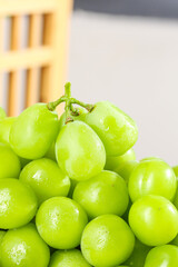 Fresh Green Grapes with Water Droplets in Sunny Kitchen Setting