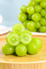 Fresh Green Grapes Cut in Half on Wooden Board - Healthy Organic Fruit