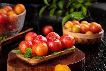 Fresh Red and Yellow Plums on Wooden Boards with Mint - Seasonal Stone Fruit Display