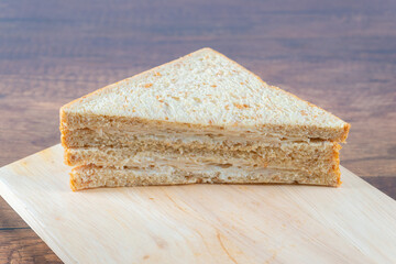 Sandwich bread on a wooden plate
