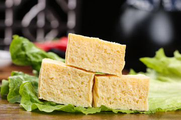 Fresh Handmade Tofu Blocks on Lettuce Leaves - Healthy Vegan Protein Ingredient for Plant-Based Cooking