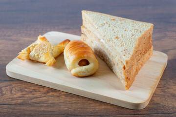 The stuffed bread is placed on a wooden plate.
