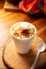 Esquites. Corn kernels cooked and served with mayo, sour cream, lemon and chili powder, very popular street food in Mexico, also known as Elote en Vaso. The recipe varies depending on the region.