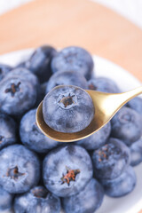 Fresh Yunnan Alpine Blueberries on Wooden Spoon - Organic Superfruit Close-up