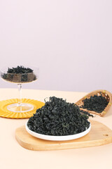 Dried Wakame Kelp Seaweed in Bowls on Wooden Board - Healthy Asian Superfood Ingredient