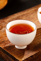Traditional Chinese Puerh Tea in White Porcelain Cups on Wooden Table - Yunnan Tea Ceremony Culture