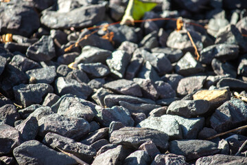 A layer of crushed rock on the ground and illuminated by the sunshine