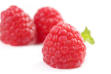 Fresh Red Raspberries on White Background with Green Leaf