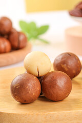 Fresh Macadamia Nuts Display on Wooden Board with Shelled and Unshelled Varieties