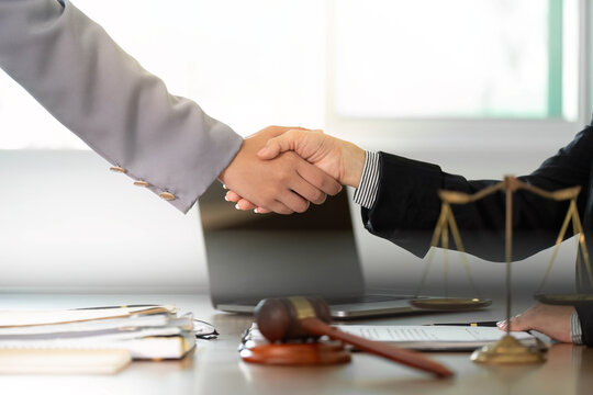 Legal Consultation. Business handshake between lawyer and client in modern office.