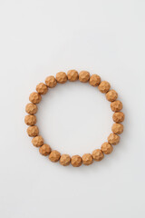 A wooden bead bracelet laid flat, showcasing natural materials and craftsmanship,Polygonal pattern engraving