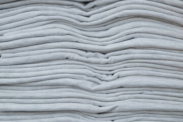 Background pattern and texture of new gray t-shirt stack.Concept of convection industry.For graphic...