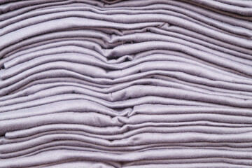 Background pattern and texture of new purple t-shirt stack.Concept of convection industry.For graphic design,3D rendering and banner background