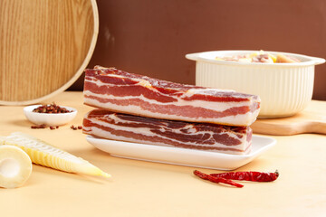 Wood Smoked Pancetta Bacon Slabs with Traditional Cooking Setup on Wooden Board