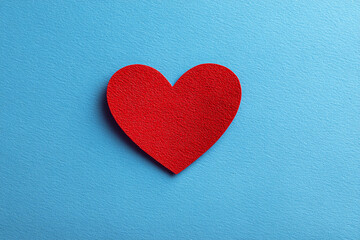 Obraz premium Red paper heart on blue background simple valentines design