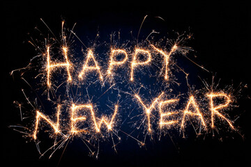 Happy New Year written in sparkling fireworks against a dark background
