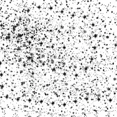 A splash of black ink creates a textured snowflake pattern against a white background