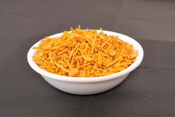 Indian snacks called Upwas Chivda or Upwas Special made fron Potatoes crispy and spicy serve on bowl isolated
