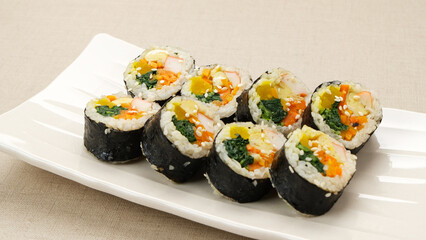 Korean Rolled Gimbap, made of rice, cucumber, tuna, carrot, sausage, crab stick and wrapped with seaweed laver. 
