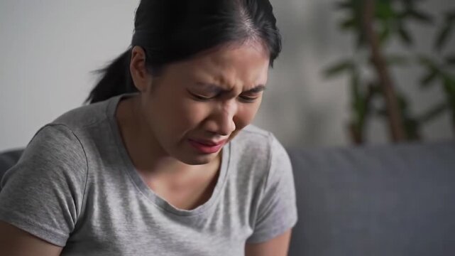 Woman at home suffering from menstrual pain
