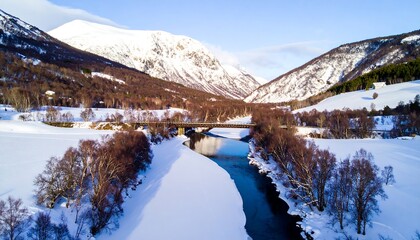 Winter Landscape with River and Snow-Covered Mountains.