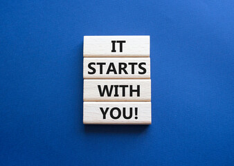 It starts with you symbol. Wooden blocks with words It starts with you. Beautiful deep blue...