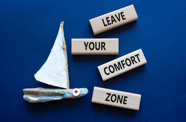 Comfort Zone symbol. Wooden blocks with words Leave your Comfort Zone. Beautiful deep blue...