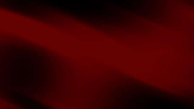 Dark red fabric cascading elegantly with shadow play, perfect for dramatic backgrounds, fashion design, and luxury product presentations.