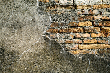Textured Wall with Cracked Concrete and Exposed Brick Surfaces