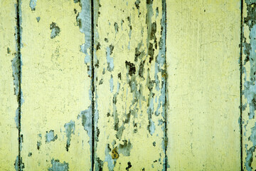 Obraz premium Aged Yellow Wooden Planks with Flaking Paint and Distressed Texture