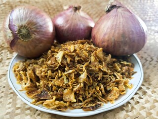 Close-up of crispy fried shallots, bright yellow and delicious.